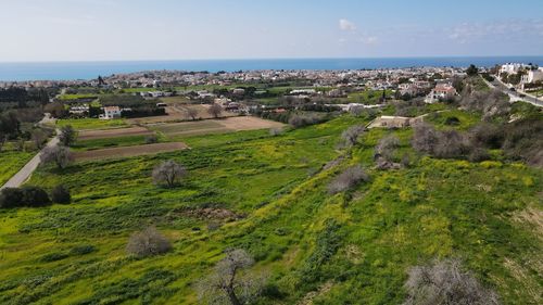 High angle view of townscape by sea against sky