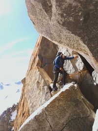 Low angle view of female climber on cliff