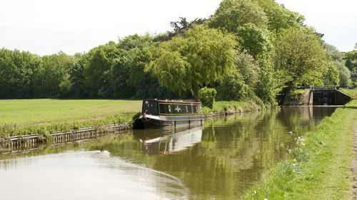 Boat in canal against sky