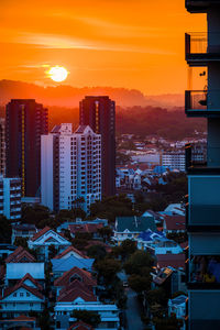 Illuminated buildings against sky during sunset