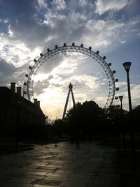 Carousel in amusement park against sky