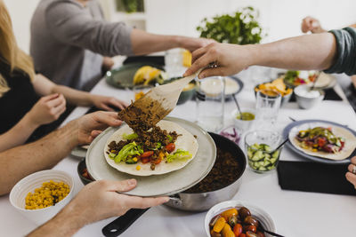 Group of friends eating mexican food at home