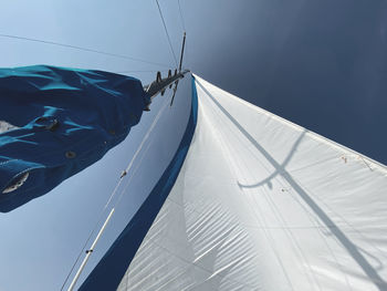 Low angle view of sailboat in sea against sky