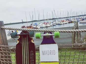 Close-up of clothes hanging by sea against sky