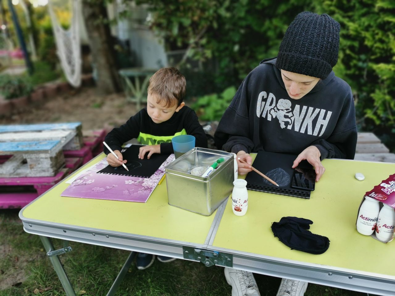 men, child, childhood, two people, table, day, communication, togetherness, sitting, outdoors, adult, nature, leisure activity, lifestyles, casual clothing, plant, clothing, person, technology