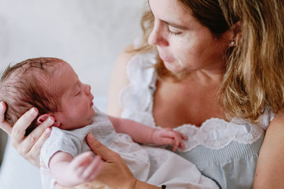 Midsection of mother and daughter baby