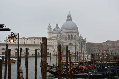 Boats in canal against clear sky