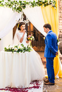 Bride talking on microphone during wedding ceremony