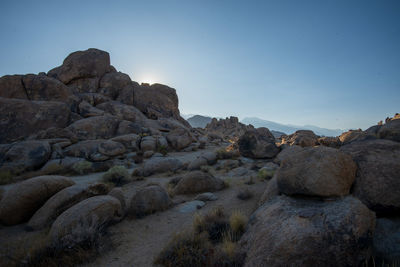 Rock formations on desert  landscape against clear sky