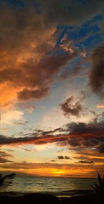 Scenic view of sea against dramatic sky during sunset