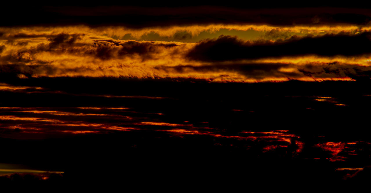 LOW ANGLE VIEW OF DRAMATIC SKY OVER SILHOUETTE LANDSCAPE