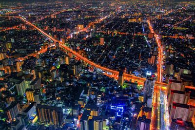 High angle view of city lit up at night