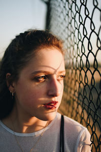 Close-up portrait of young woman looking away