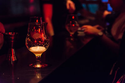 High angle view of illuminated glass on table at restaurant