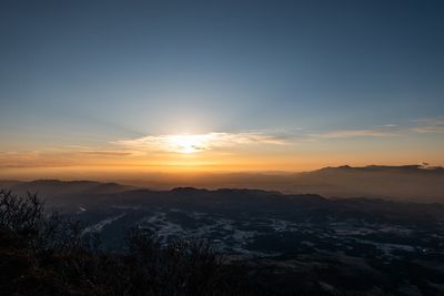 Scenic view of silhouette mountains against sky during sunset