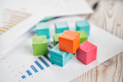 High angle view of colorful toy blocks with document on table