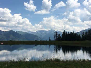 Scenic view of lake and mountains against sky