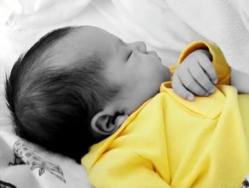 Close-up of boy lying on bed