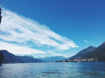 Scenic view of sea and mountains against sky