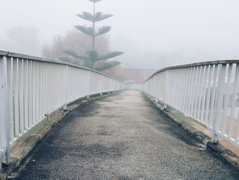 Empty bridge during foggy weather