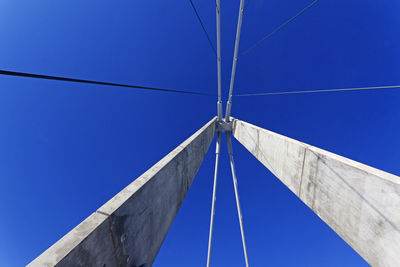 Low angle view of bridge against blue sky