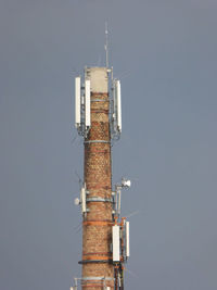 Low angle view of communications tower against sky