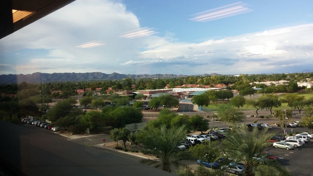 HIGH ANGLE VIEW OF PARKING LOT AGAINST SKY