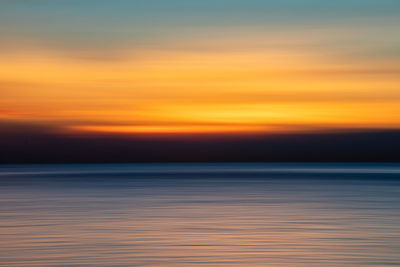 Scenic view of sea against romantic sky at sunset