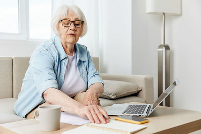 Young woman using laptop at home