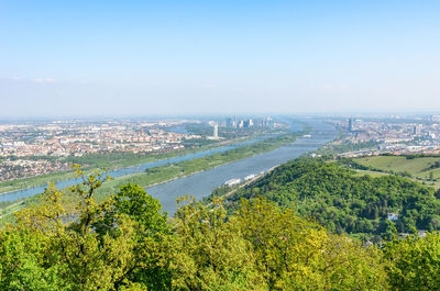 High angle view of river and buildings against sky