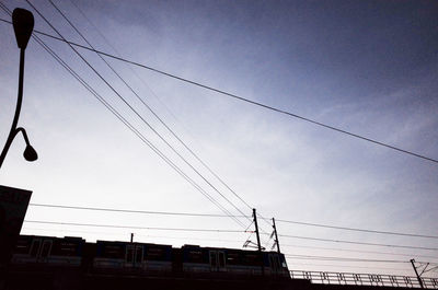 Low angle view of power lines against sky