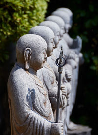 Statues in row at park