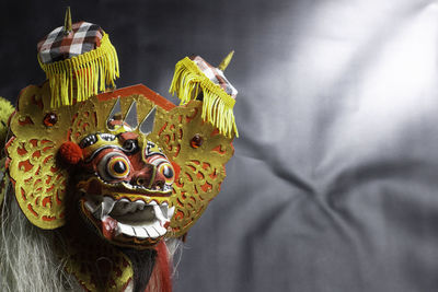 Colorful replica barong bali with a black background
