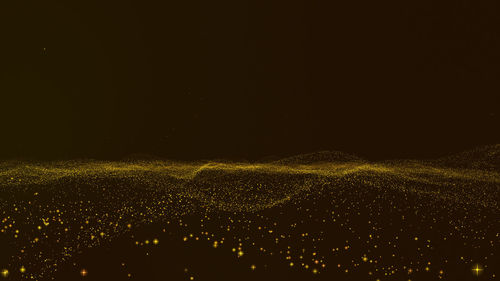 Illuminated cityscape against sky at night