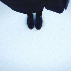 Low section of man standing on ground