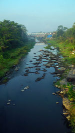 High angle view of river amidst trees against sky