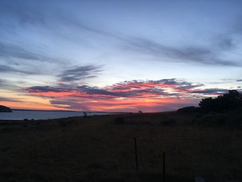 Scenic view of dramatic sky over landscape during sunset