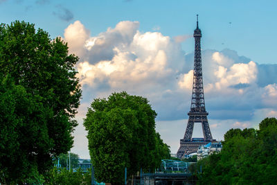 Eiffel tower against cloudy sky