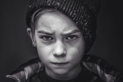 Close-up portrait of boy wearing hat