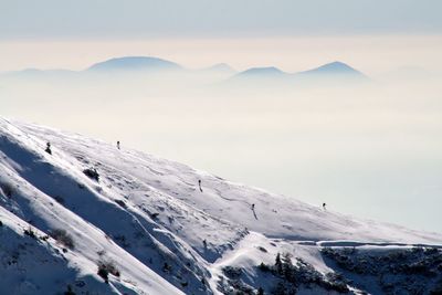 Scenic view of snow covered mountains against sky