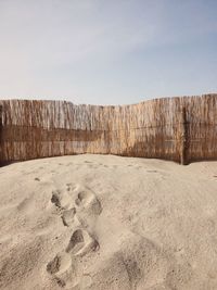 Rustic fence on sandy beach