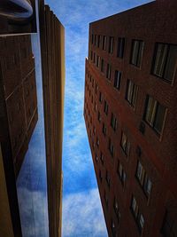 Low angle view of office building against blue sky