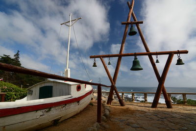 Lifeguard hut on beach against sky