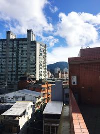 Buildings in city against sky