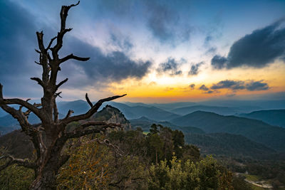 Scenic view of mountains against sky at sunset