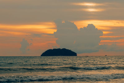 Scenic view of sea against orange sky