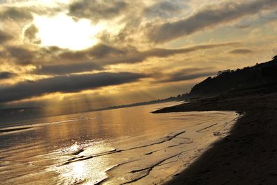 Scenic view of beach against sky during sunset