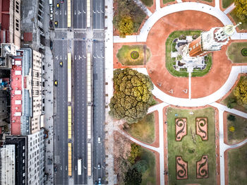 Aerial view of street by buildings in city