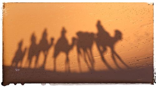 Shadow of hand on person against sky