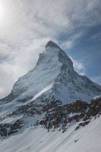 Scenic view of snowcapped matterhorn mountain against sky